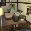 Kaori Nishidake in The Sims 4 sat at a desk using a PC in her home in Mt Komorebi. It's a tatami-style room decorated with postcards and trinkets.